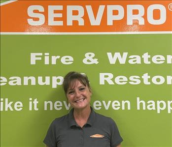 SERVPRO employee in front of green background