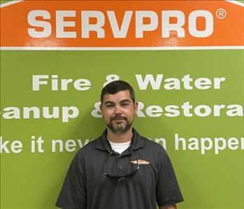 SERVPRO employee in front of green background