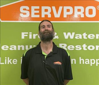 SERVPRO employee in front of green background